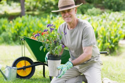Operative finishing a tidy, mown lawn in a residential garden